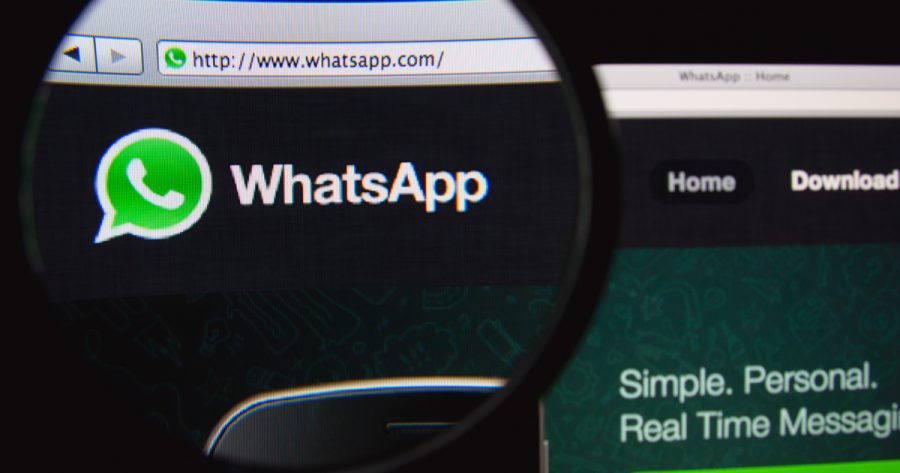 WhatsApp homepage on a through a magnifying glass